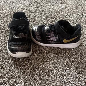 Nike Kids Black Sneakers with Gold Swoosh